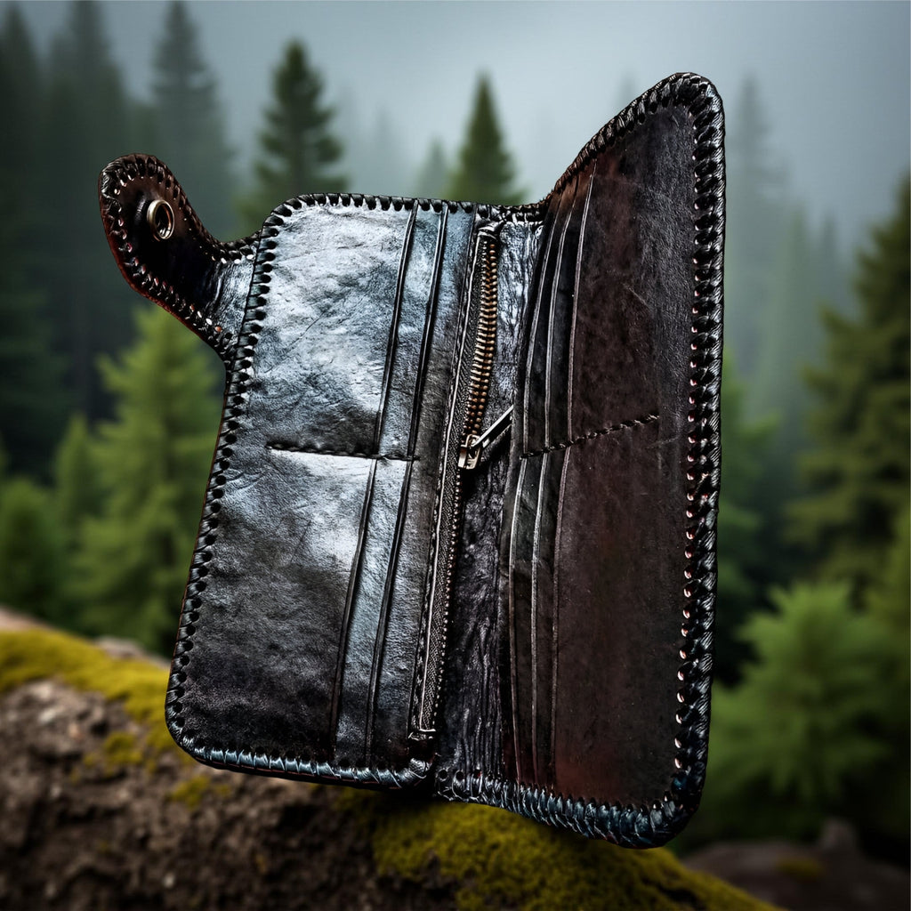 Open leather wallet with metallic interior on a rock with a forest background