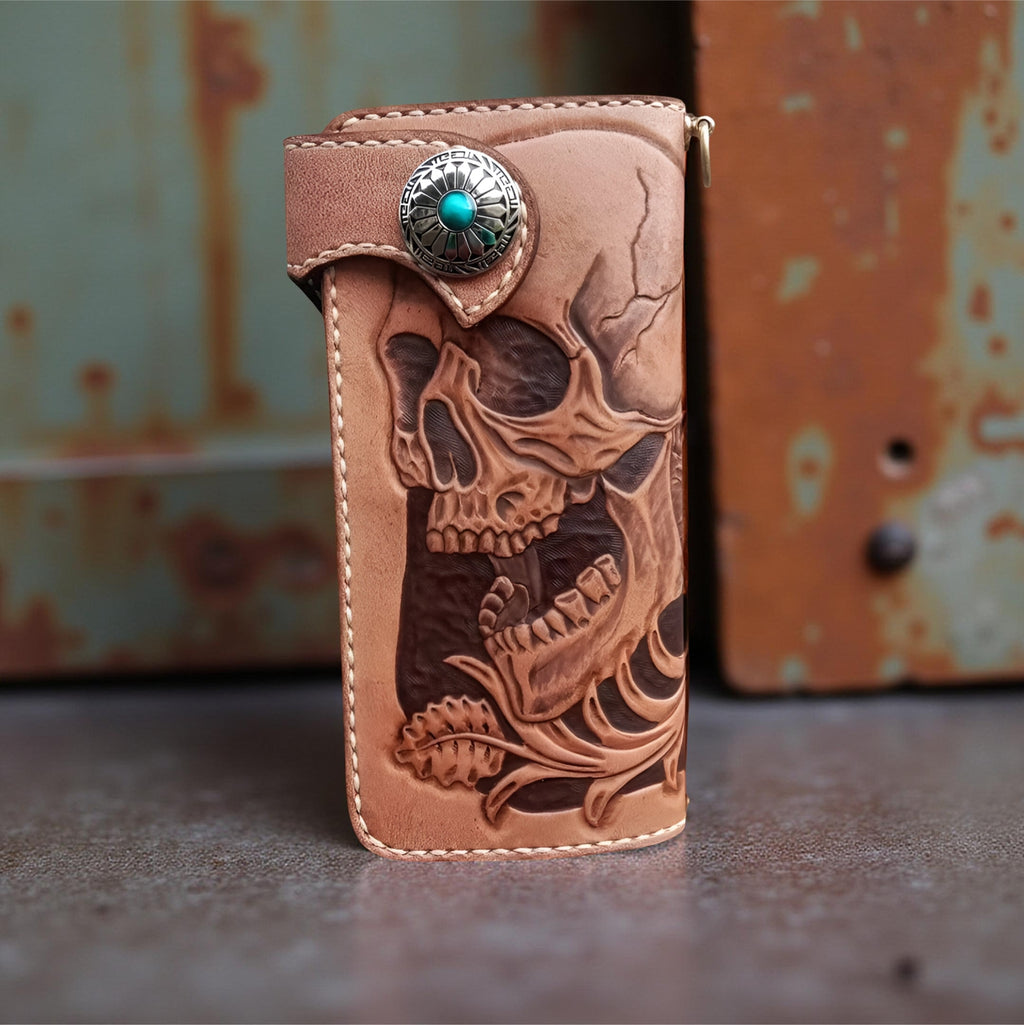 Front brown leather wallet with skull design and turquoise stone on a textured surface