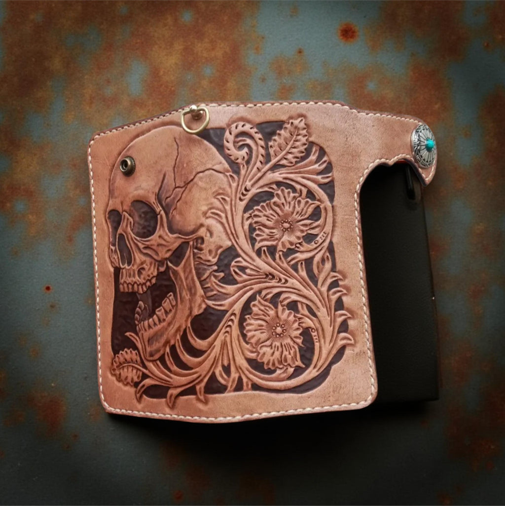 Up Middle brown leather wallet with skull design and turquoise stone on a textured surface