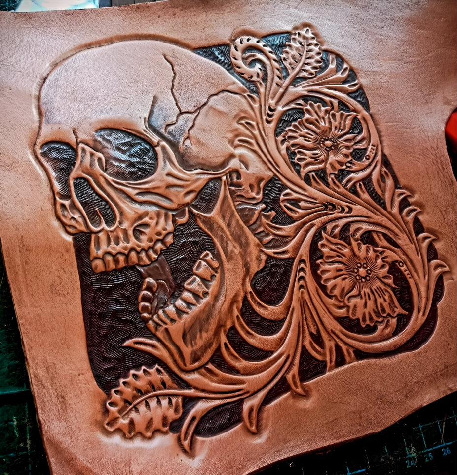 Process brown leather wallet with skull design and turquoise stone on a textured surface